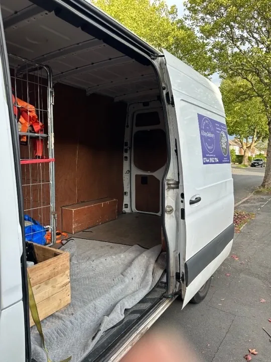 House removals — branded removals van 6 Days Logistics branded removals van with side door open, moving blankets laid out and equipment ready for a professional house removal