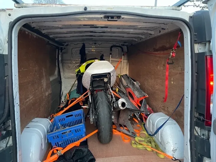 Man and van — motorcycle secured for transport Motorcycle secured with ratchet straps inside a man and van removals vehicle for specialist UK motorcycle transport