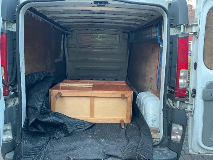 Small moves — sideboard furniture transport Mid-century sideboard loaded on moving blankets inside a removals van for a single-item small-move furniture delivery