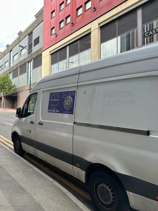 6 Days Logistics branded removals van parked on a city street advertising student moves, man and van, and packing services